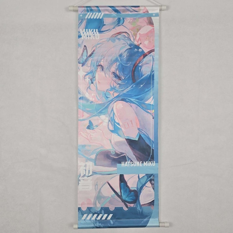 May include: A vertical wall scroll featuring a blue-haired anime character with butterflies. The artwork has a pastel color palette with the text "Hatsune Miku" at the bottom. The scroll is held by white rods at the top and bottom.