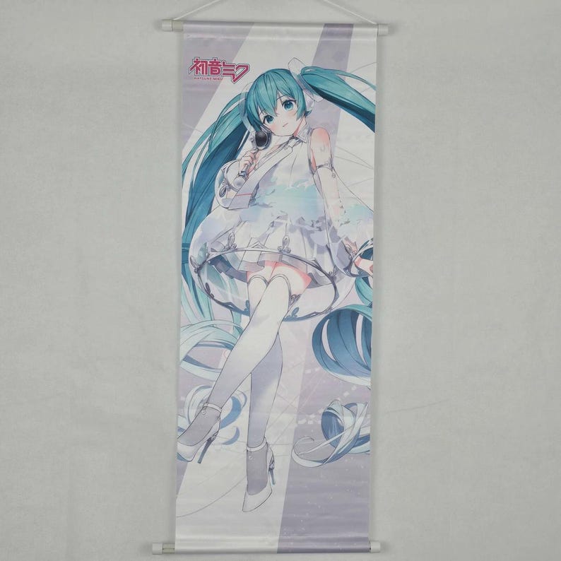 May include: A wall scroll featuring a manga-style illustration of a female character with long turquoise hair and a white dress. The character is holding a microphone. The text "初音ミク" is at the top.