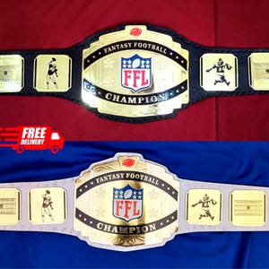 May include: Two fantasy football championship belts. The belts have a gold-colored center plate with the text "FANTASY FOOTBALL CHAMPION" and the letters "FFL" inside a shield. The belts have black and silver straps and gold-colored side plates with football player graphics.