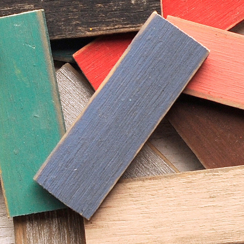 May include: A collection of wooden planks painted in various colors, including teal, blue, red, and brown. The planks are arranged in a random pattern, creating a visually interesting display.