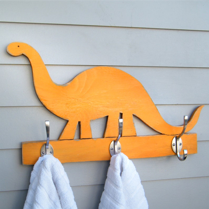 Our Florida Orange dinosaur-shaped wooden wall-mounted towel rack with three metal hooks. Select from 27 Colors and 2 Hook finishes. By Haven America