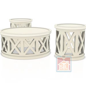 May include: Three cream-colored accent tables. The largest is oval, the others are round. Each has a solid top and a decorative lattice design on the sides. The tables are suitable for a living room or bedroom.