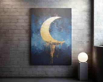 May include: Abstract canvas art featuring a gold crescent moon against a blue and dark blue background. The moon has dripping gold paint. The artwork is displayed on a brick wall, with a modern lamp on a pedestal.