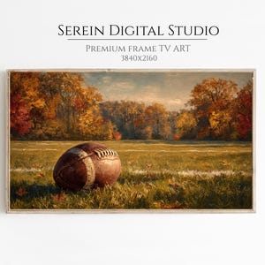May include: A framed digital art print featuring a vintage football on a grassy field. The artwork showcases a fall landscape with trees in shades of red, orange, and yellow. The image is labeled "Serien Digital Studio" and "Premium Frame TV Art".