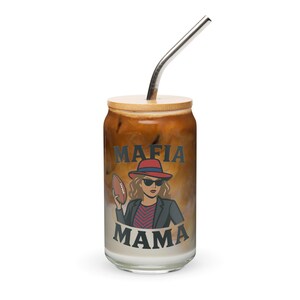 May include: A glass tumbler with a bamboo lid and a stainless steel straw. The tumbler features a graphic of a woman in a hat and sunglasses holding a football, with the words "MAFIA MAMA" printed above and below the image.