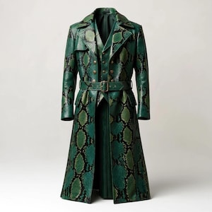 May include: A long, green trench coat featuring a prominent snakeskin pattern in shades of dark green and black. The coat includes a notched lapel, a double-breasted button closure, long sleeves, and a matching belt with a rectangular metal buckle.