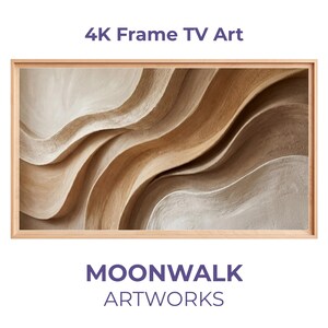 Puede incluir: Una obra de arte para TV 4K enmarcada con un diseño abstracto de formas fluidas y superpuestas en tonos beige y marrón. La obra de arte se titula "MOONWALK ARTWORKS". El marco es de madera clara.