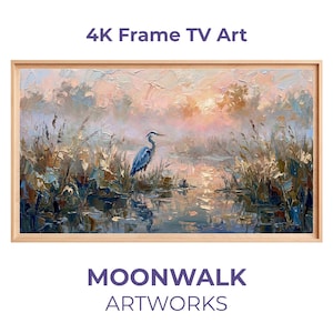 Può includere: Un'opera d'arte incorniciata intitolata "4K Frame TV Art" raffigurante un paesaggio sereno con un airone blu vicino all'acqua. Il dipinto ha una cornice in legno chiaro e il testo "MOONWALK ARTWORKS" in basso.