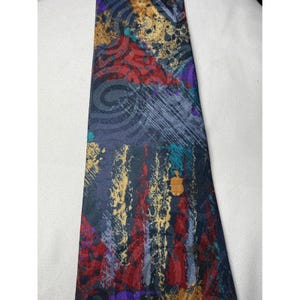 May include: A patterned necktie with a dark background and a mix of abstract designs in red, gold, purple, and teal. The tie features a variety of shapes and textures, creating a visually complex and artistic accessory.