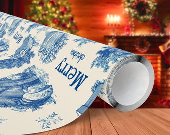 May include: A roll of cream-colored wrapping paper with a blue toile design featuring Christmas scenes and the words "Merry Christmas." The paper is partially unrolled, revealing the pattern. The background shows a Christmas tree and fireplace.