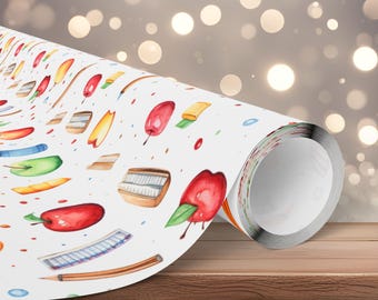May include: A roll of white wrapping paper with a watercolor pattern of red apples, yellow pencils, and other school-themed illustrations. The paper is rolled up on a wooden surface, with a blurred background of bokeh lights.