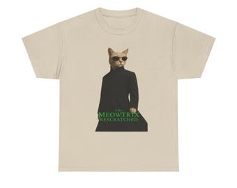 May include: Beige t-shirt featuring a cat wearing sunglasses and a black coat, a parody of a movie character. The text "THE MEOWTRIX RESCRATCHED" is printed in green below the cat.