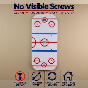 May include: A white light switch cover plate featuring a red and blue ice hockey rink graphic. The text reads No Visible Screws, Clean, Modern, Easy to Swap, Tool-Free Swap, Change Look Anytime, and Great for Any Room with corresponding icons.