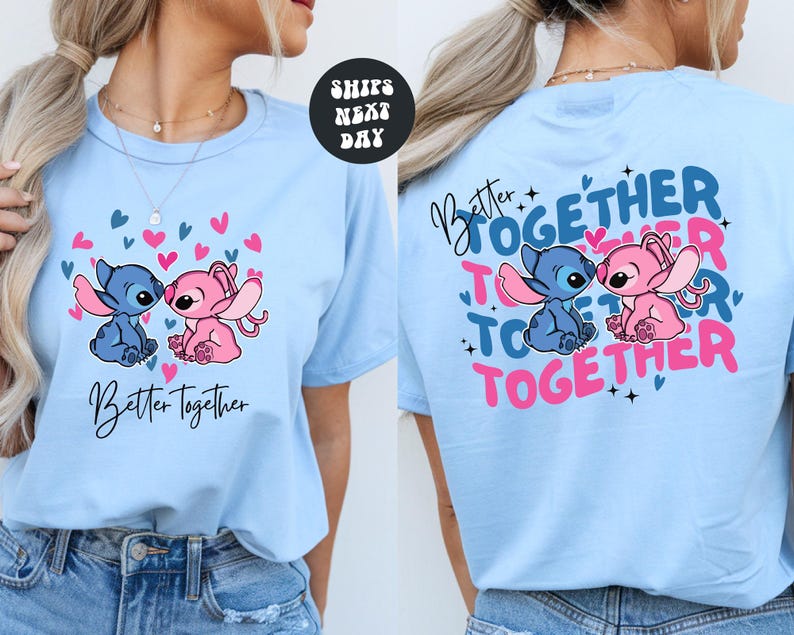 A woman wearing a light blue t-shirt with a graphic design featuring two cartoon characters, one pink and one blue, along with the text "Better Together" and "Together".