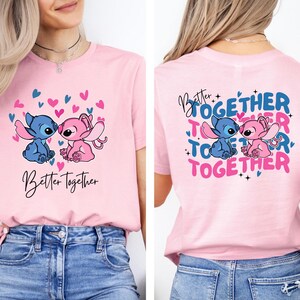 A woman wearing a pink t-shirt with a graphic design featuring two cartoon characters, one pink and one blue, along with the text "Better together" and "Together".