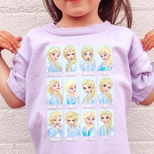 A child wearing a pink t-shirt with a collage of cartoon images depicting different emotions of a character from the Disney movie Frozen.
