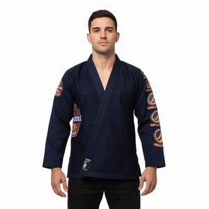 May include: A navy blue Jiu-Jitsu gi with orange and white logo patches on the sleeves and chest. The gi has a V-neck and is made of a robust fabric. This gi is designed for martial arts training and competition.