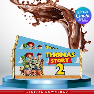 May include: A rectangular candy bar wrapper featuring a light blue background with a group of animated toy characters, including a cowboy, space ranger, and dinosaur. The text reads THOMAS STORY 2 in bold yellow and red letters. Gold foil ends.