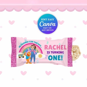 May include: Pink candy bar wrapper with glittery pink edges. The wrapper features a rainbow, cartoon characters, and the text "RACHEL IS TURNING ONE!" A blue and teal Canva logo is in the upper right corner.