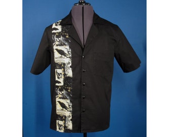 May include: A black short-sleeved button-down shirt with a white and gold print of skulls and ravens down the left side.