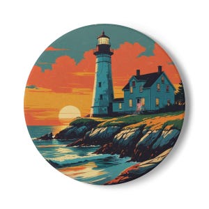 May include: Circular decorative item depicting a lighthouse at sunset. A tall, white lighthouse stands beside a blue house on a rocky coast. The sky is a blend of orange and red, and the sea is a deep blue. The overall theme is coastal.