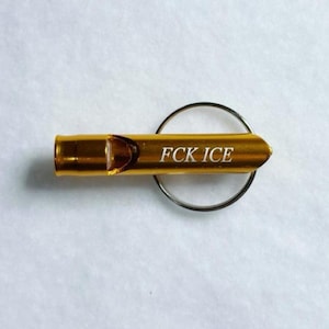 Emergency Whistle Keychain Safety Device Compact Design Aluminum Construction Protest Tool Accessory Political Statement Piece Multiple Color Options Available Everyday Carry Size Functional Alert System Metal Ring Attachment Activism Gear Gold/Bronze Color