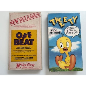 May include: Two vintage Walt Disney Home Video VHS tapes. One features "Off Beat" with text "New Releases!" and "This Year's Most Arresting Comedy!". The other is a "Tweety and Friends" tape with Tweety Bird. Both tapes have colourful graphics.