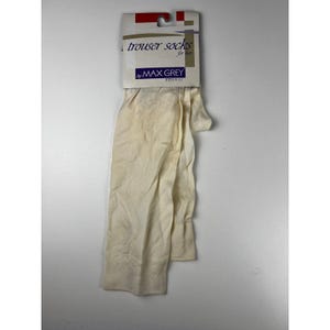 May include: Off-white trouser socks by Max Grey, fits sizes 9-11, with original packaging. The packaging is white, red, and purple. The socks are folded and appear to be made of a soft, lightweight material.