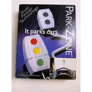May include: A product box for the Park-Zone parking assist system. The box features a graphic of the device with red, yellow, and green lights, and the text "It parks cars." The Platinum Edition is also noted.