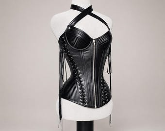 Top a corsetto in pelle di pecora nera, con scollo all'americana e cerniera frontale, allacciatura posteriore.