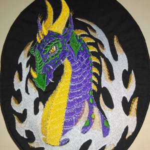 May include: Purple and yellow embroidered dragon patch with white flames on a black background.