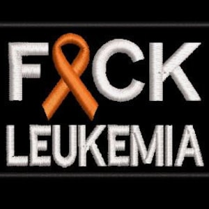 May include: Black and white embroidered patch with the text "F*CK LEUKEMIA" and an orange ribbon.