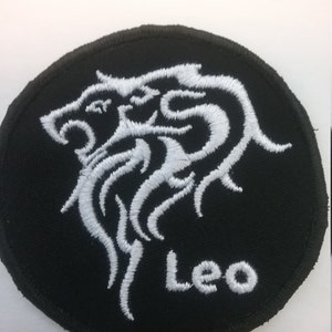 May include: White embroidered lion zodiac symbol on a black circular patch with the word "Leo" below it.