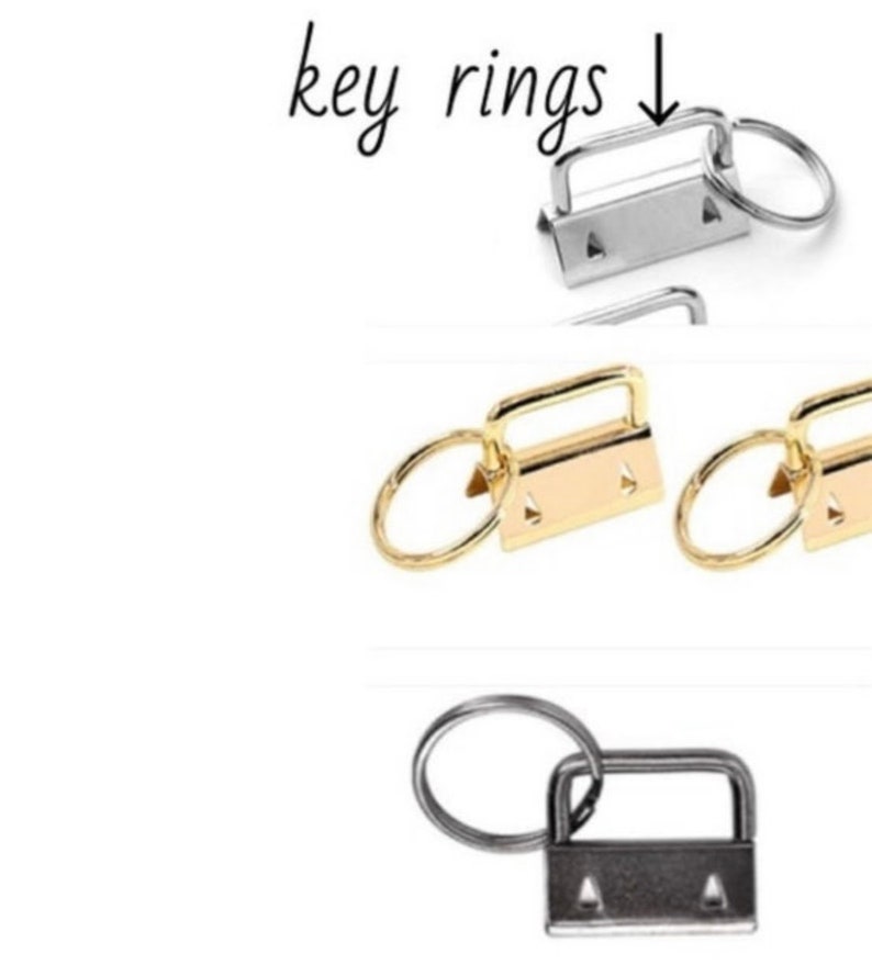 May include: Three key rings with a swivel clasp and a metal ring. The key rings are silver, gold, and black.
