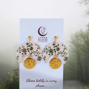 Celestial Garden Earings - hand made, lightweight with soft arc of green florals, cradles a golden charm etched with stars.