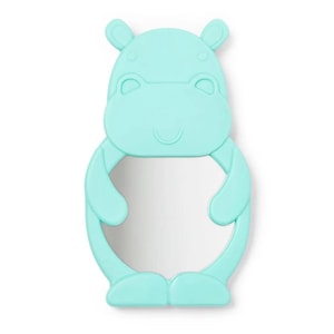 May include: A light blue hippo-shaped mirror with a smiling face, ears, arms, and legs. The mirror is surrounded by a soft, rounded frame. The mirror is designed for children.