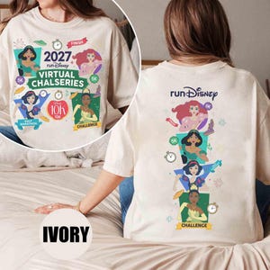 May include: An ivory t-shirt featuring a graphic print of Disney princesses and race icons. The front displays '2027 runDisney VIRTUAL CHALSERIES' with character illustrations. The back shows a vertical arrangement of the same characters and race logos.