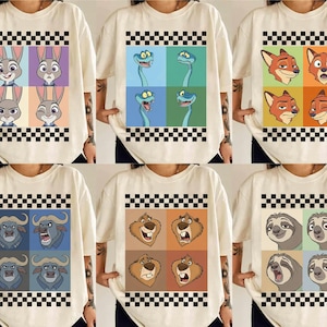 Puede incluir: Camisetas color crema con diseños de personajes de dibujos animados. Cada camiseta muestra un conjunto diferente de personajes en un patrón de cuadrícula, con un borde a cuadros en blanco y negro. Los personajes incluyen conejos, serpientes, zorros, toros, osos y perezosos.