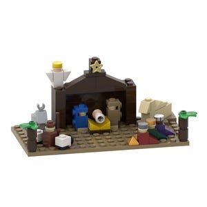 May include: A miniature nativity scene constructed from plastic building blocks. The set features a dark brown stable with a yellow star on top, a white angel, and various figures in blue, tan, and red. Small animal figures and green palm trees are included.