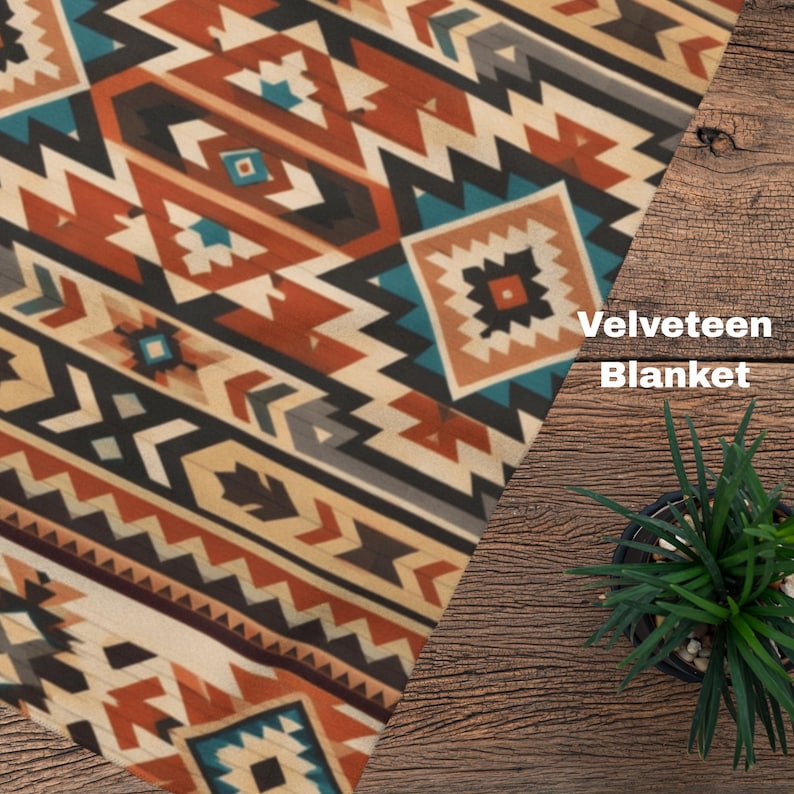 May include: A velveteen blanket featuring a geometric pattern in shades of burnt orange, teal, cream, black, and brown. The fabric displays repeating diamond and chevron shapes arranged in diagonal stripes across the surface of the textile.