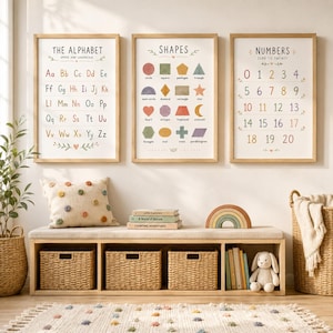 May include: Three framed educational posters featuring the alphabet, shapes, and numbers zero to twenty in muted colors. Below, a wooden bench with a beige cushion holds three woven baskets, a rainbow decor piece, and a plush rabbit toy.