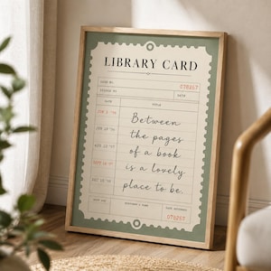 May include: A framed wall art print featuring a vintage library card design in sage green and cream. The text reads LIBRARY CARD, 078267, and the quote: Between the pages of a book is a lovely place to be. Includes dates from 1996 to 1998 in red ink.