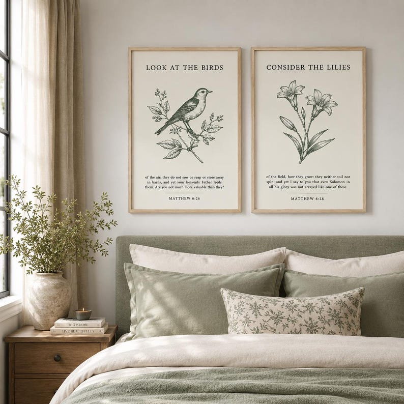 May include: Two rectangular wall art prints in light wood frames featuring cream backgrounds. The left print shows a bird on a branch with the text "LOOK AT THE BIRDS" and "MATTHEW 6:26". The right print shows lilies with "CONSIDER THE LILIES" and "MATTHEW 6:28".