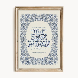 May include: A framed print with a cream background and blue floral border. The text reads "LOVE, JOY, PEACE, PATIENCE, KINDNESS, GOODNESS, FAITHFULNESS, GENTLENESS, SELF CONTROL" from Galatians 5:22-23.