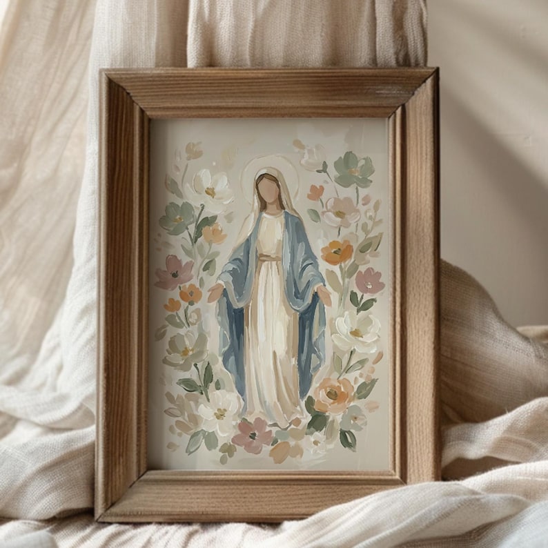 May include: A framed watercolor painting of a figure in a white dress and blue cloak, surrounded by flowers in soft pastel colors. The artwork is set in a natural wood frame, creating a serene and artistic aesthetic.