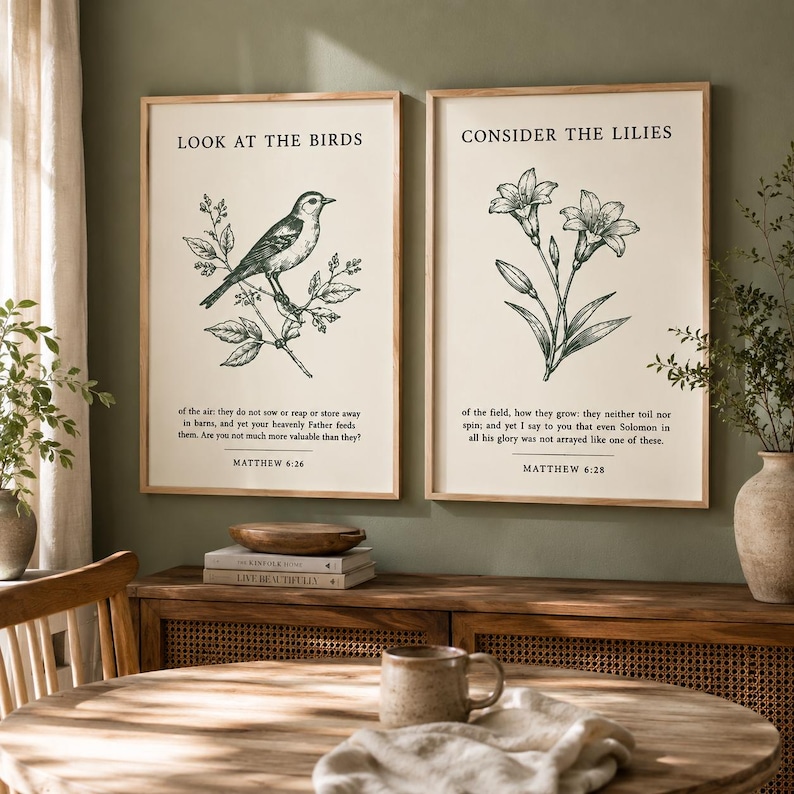 May include: Two rectangular wall art prints in light wood frames. The left print features a bird illustration with the text LOOK AT THE BIRDS and Matthew 6:26. The right print features a lily illustration with the text CONSIDER THE LILIES and Matthew 6:28.