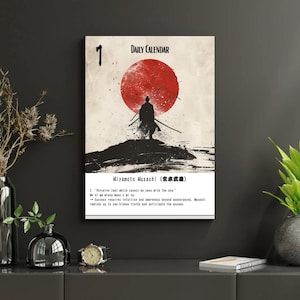 May include: A framed print featuring a samurai silhouette against a red sun, with the text "DAILY CALENDAR" and "Miyamoto Musashi." The print includes a quote about perception and intuition, with Japanese characters.
