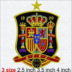 May include: An embroidered patch featuring the Spanish coat of arms on a black shield with a yellow border. It includes a crown, two pillars with red ribbons reading PLUS ULTRA, the numbers 19 and 09, a star, and a football. Sizes: 6.35, 8.89, 10.16 cm.