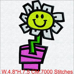 May include: Embroidered flower design with a smiling yellow face, white petals, and a green stem in a pink pot. The design measures 4.8 cm wide by 7.5 cm high.