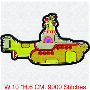 May include: Embroidered patch of a yellow submarine with red and black accents. The design includes a black outline, red portholes, and a pink and blue interior. The text at the bottom reads "W.10 *H.6 CM. 9000 Stitches."